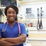 portrait of female nurse in emergency room smiling at camera